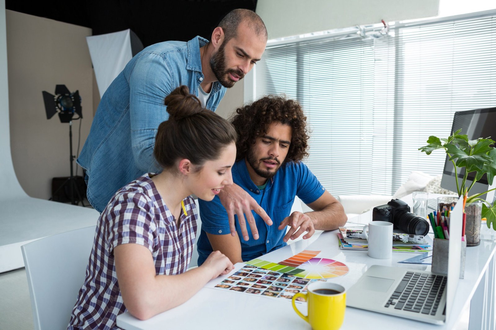 Graphic Design 36 team photographers working together desk scaled 1